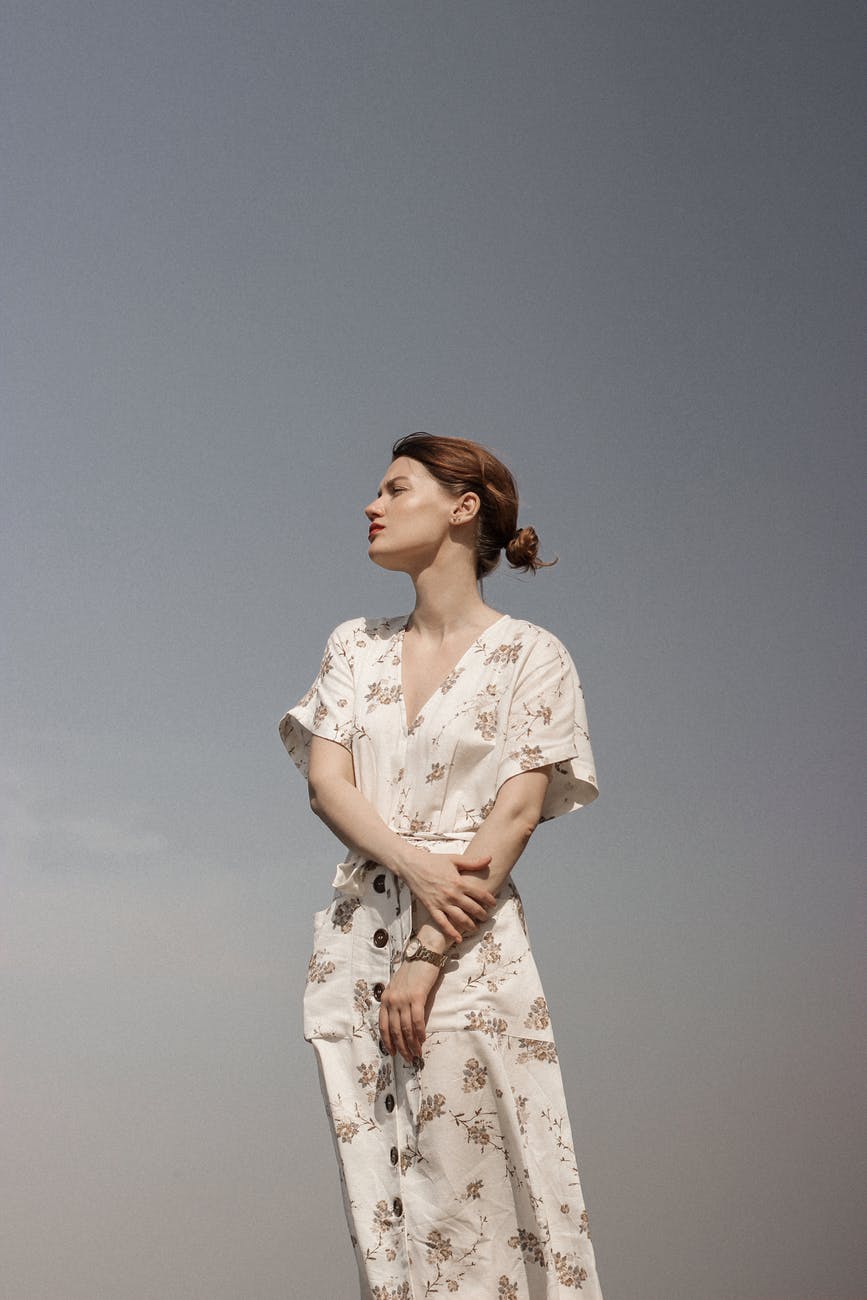 woman in white and brown floral dress