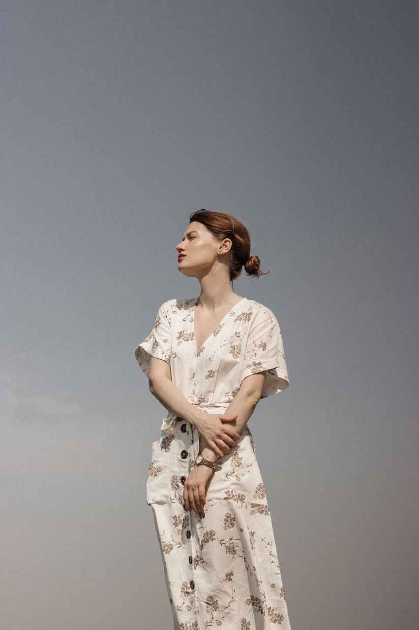 woman in white and brown floral dress